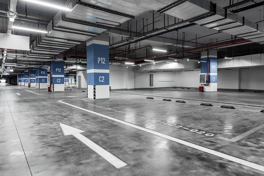 Empty and bright underground parking lot Photograph by Jun Xu