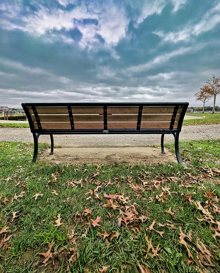 Empty Bench Under Stormy Sky In Autumn Photograph by Gary Slawsky