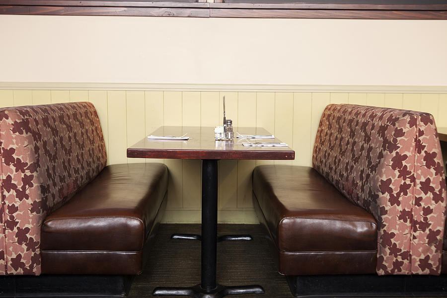 Empty booth and table in restaurant Photograph by Ronnie Kaufman