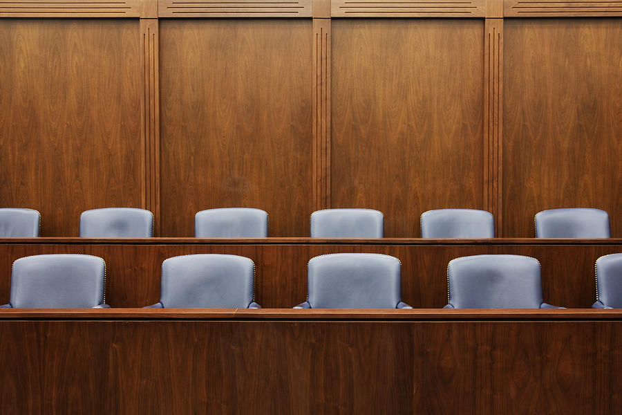 Empty chairs in jury box Photograph by Mint Images