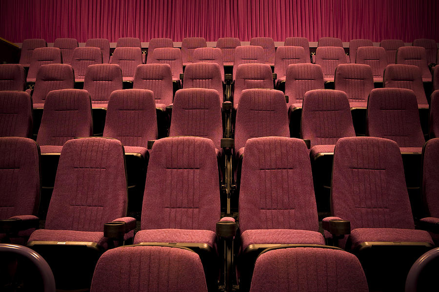 Empty chairs in movie theater. Photograph by Heath Korvola