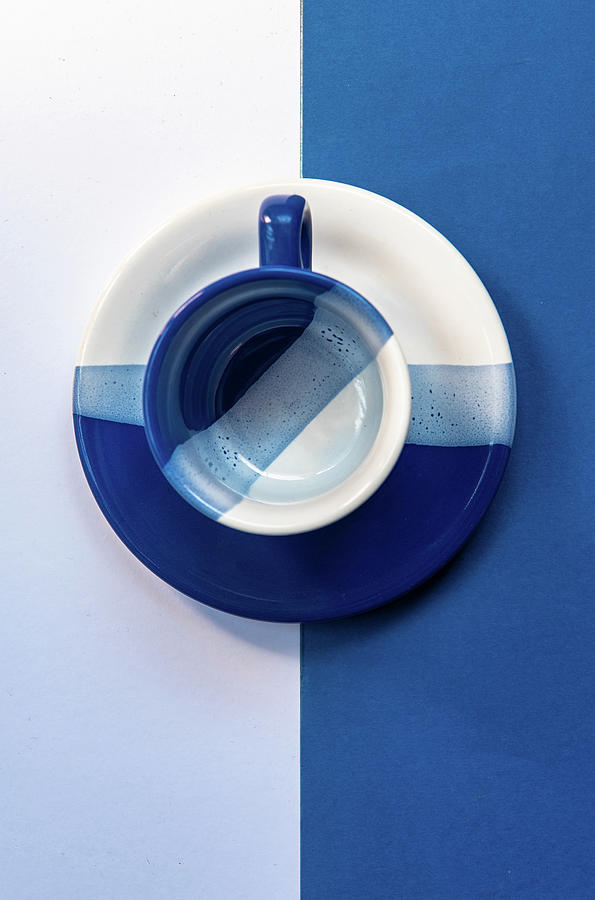Empty Coffee Mug And Plate On A Blue And White Background. Minimalism Art Photograph