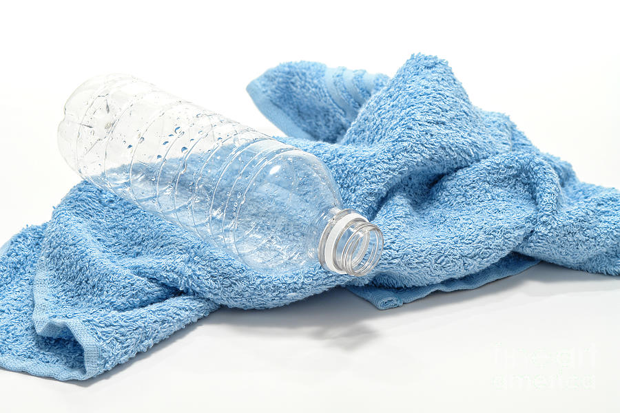 Empty Discarded Trash Plastic Water Bottle and Towel Photograph by Olivier Le Queinec