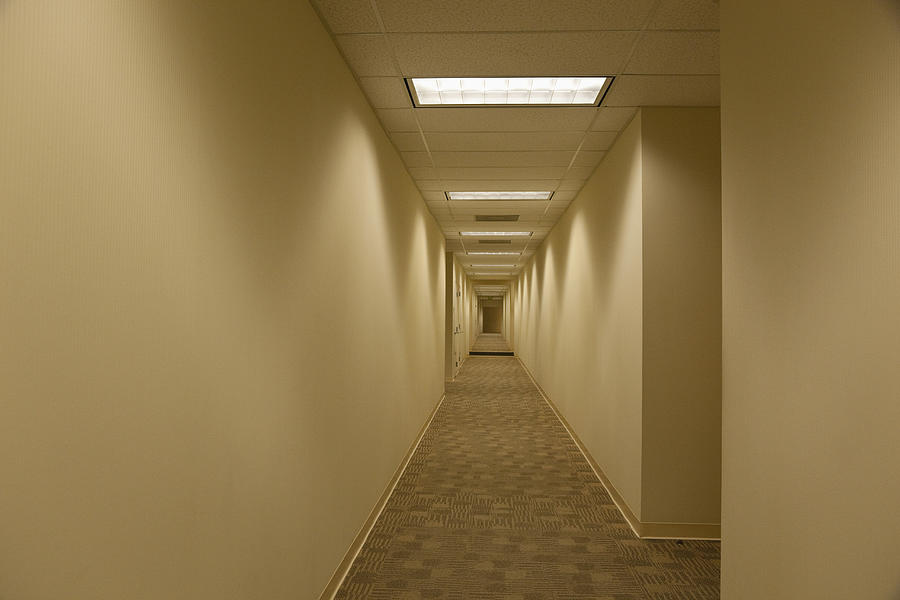 Empty hallway in office building Photograph by Tanya Constantine