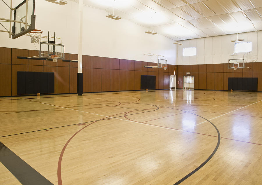 Empty indoor basketball court Photograph by Andersen Ross