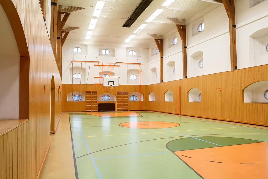 Empty interior of public gym with basketball court Photograph by Artush