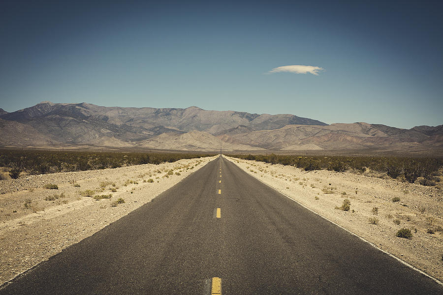 Empty road in desert Photograph by Johner Images