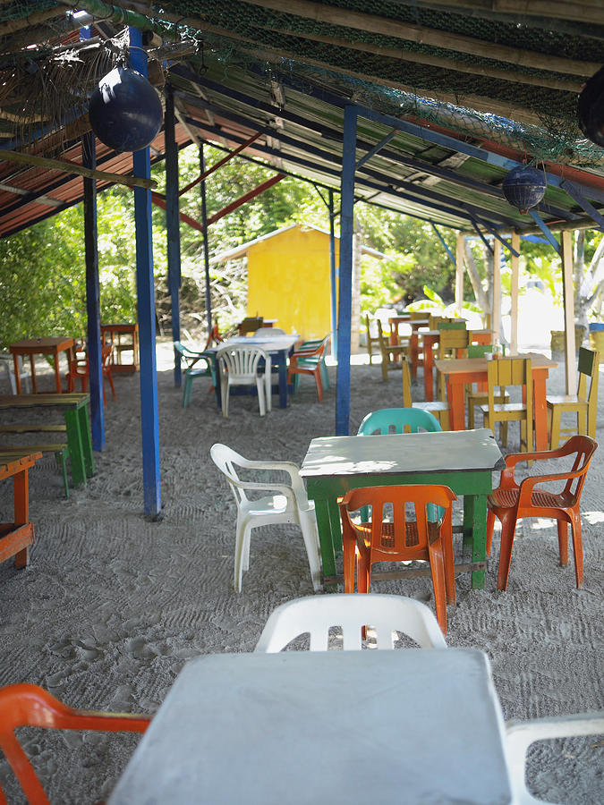 Empty tables and chairs in a restaurant, Providencia, Providencia y Santa Catalina, San Andres y Providencia Department, Colombia Photograph by Glowimages