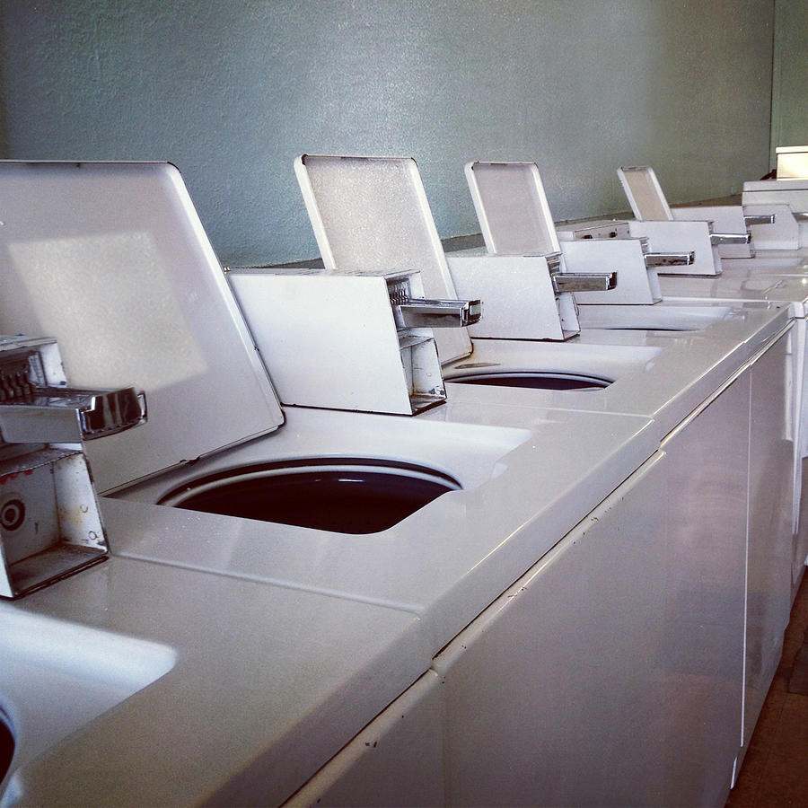 Empty washing machines at laundromat Photograph by Jodie Griggs