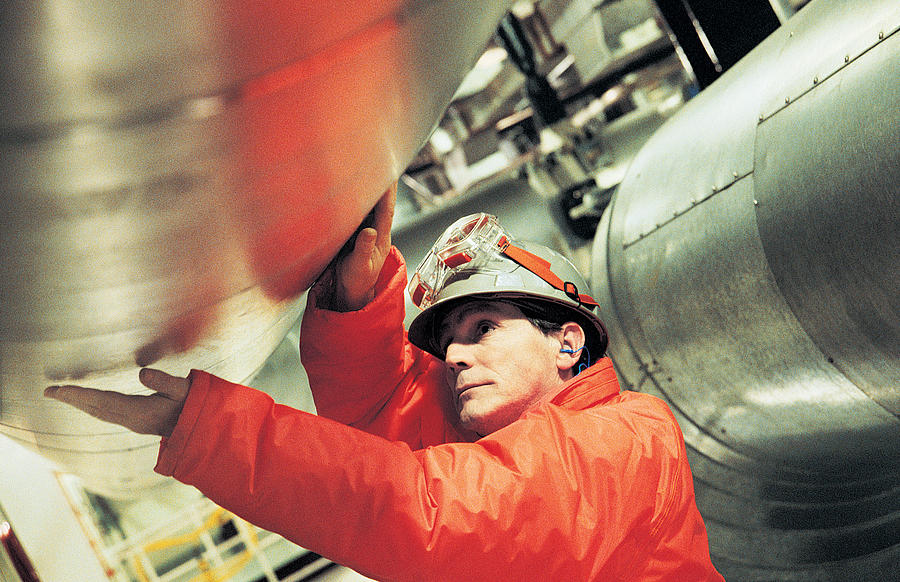 Engineer touching pipe in nuclear power station Photograph by Digital Vision.