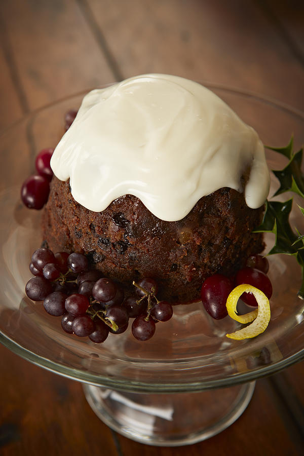 English plum pudding with custard sauce Photograph by Tracey Kusiewicz/Foodie Photography