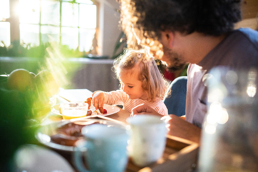 Enjoying a wholesome breakfast with dad Photograph by Miodrag Ignjatovic