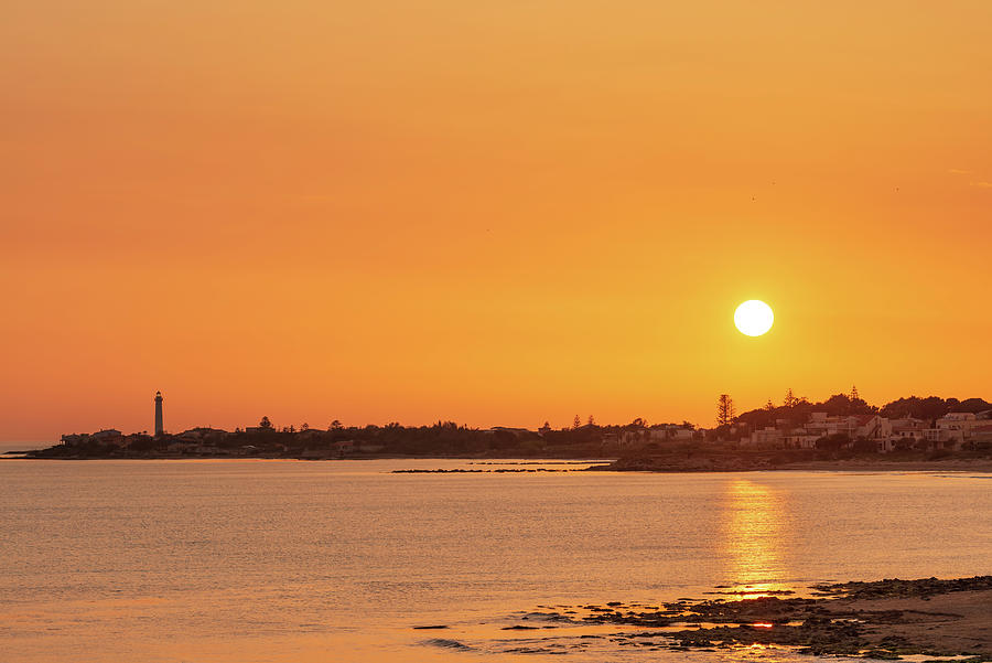 Enjoying an orange warm sunset over the sea in Sicily Photograph by Mirko Chessari