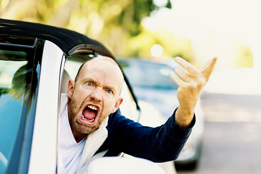Enraged male driver shouts and gestures threateningly Photograph by RapidEye