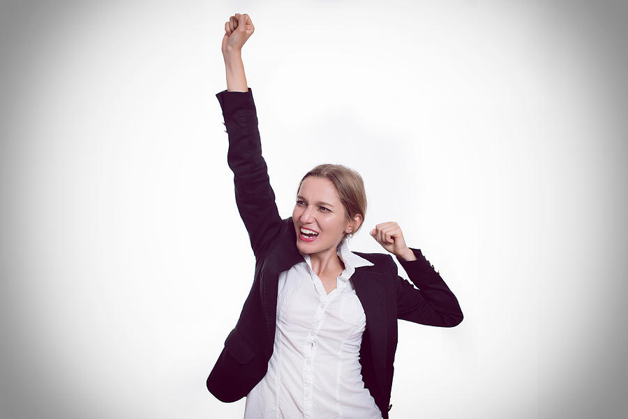 Enthusiastic businesswoman with one arm raised Photograph by Emilija Manevska