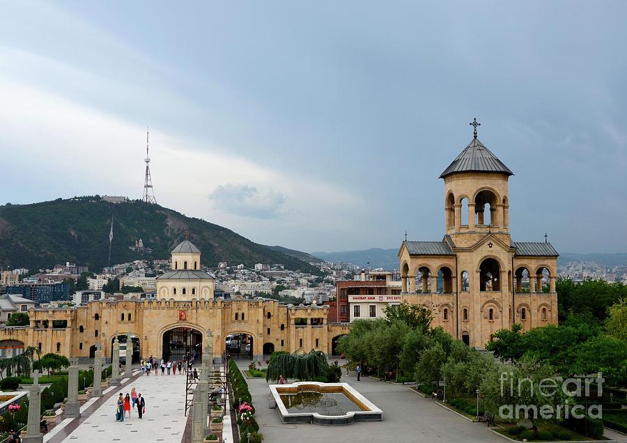 Entrance archway bell tower and city building Holy Trinity Sameba Cathedral Tbilisi Georgia Photograph by Imran Ahmed