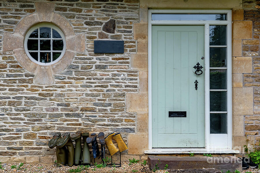 Entrance Of A Cottage With Rubber Boots Of Different Size Beneath The Door In England Photograph by Andreas Berthold