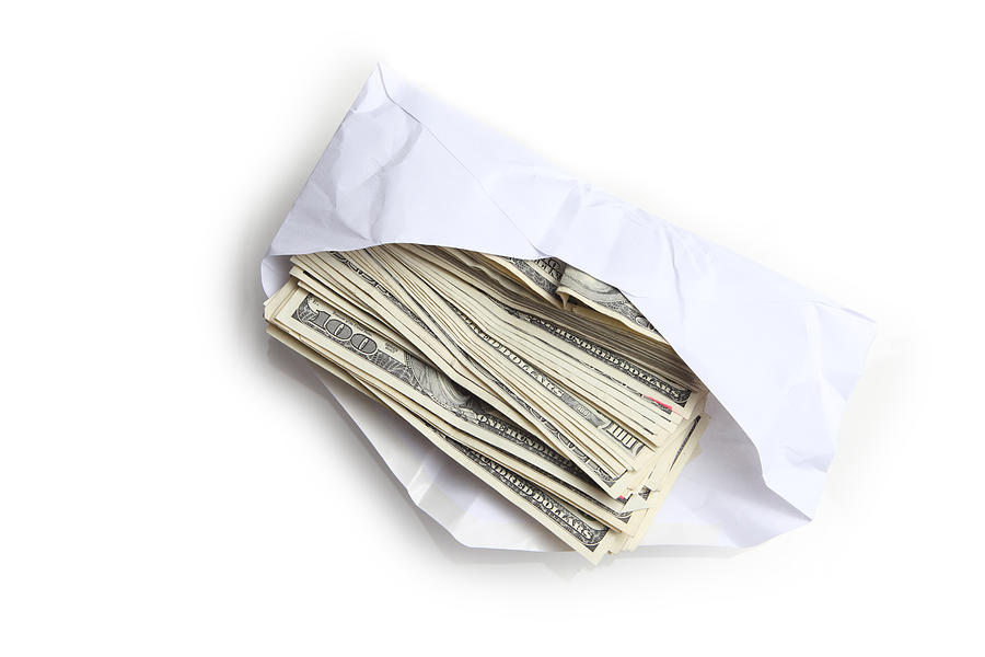 Envelope filled with stack of hundred dollar bills Photograph by Dlinca