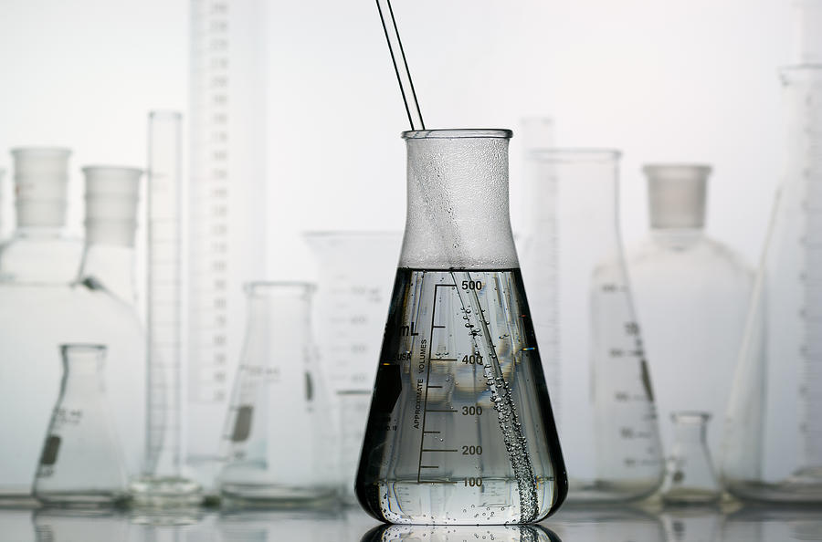 Erlenmeyer Flask with Laboratory Glassware in the Background Photograph by ElementalImaging