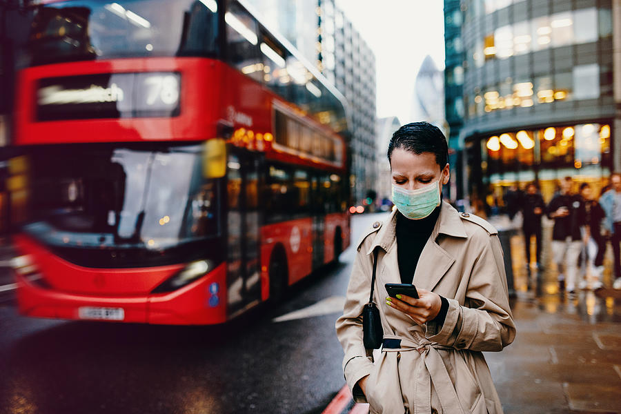 Essential worker in London with face mask going back home after work with face mask on Photograph by Drazen_