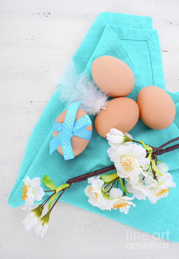 Ester eggs on blue and white background. Photograph by Milleflore Images