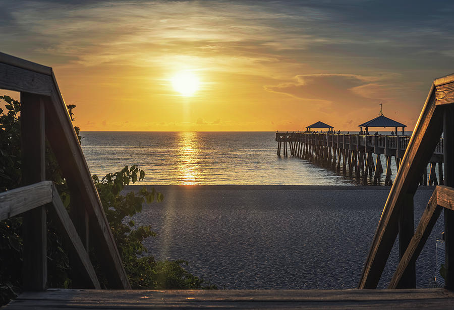 Ethereal Sunrise at Juno Beach Pier A Tranquil Coastal Journey Photograph by Kim Seng