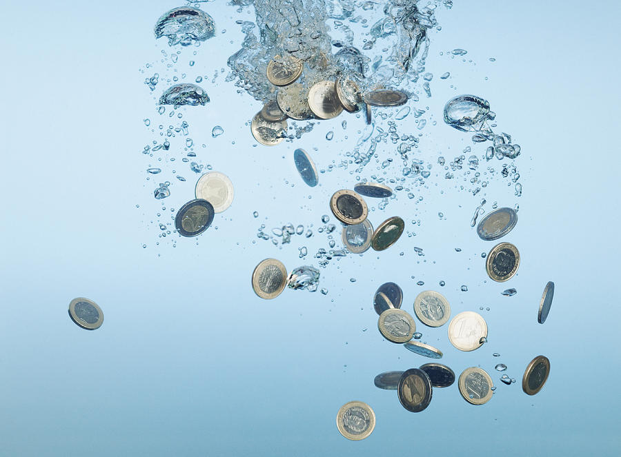 Euro coins splashing in water Photograph by Martin Barraud