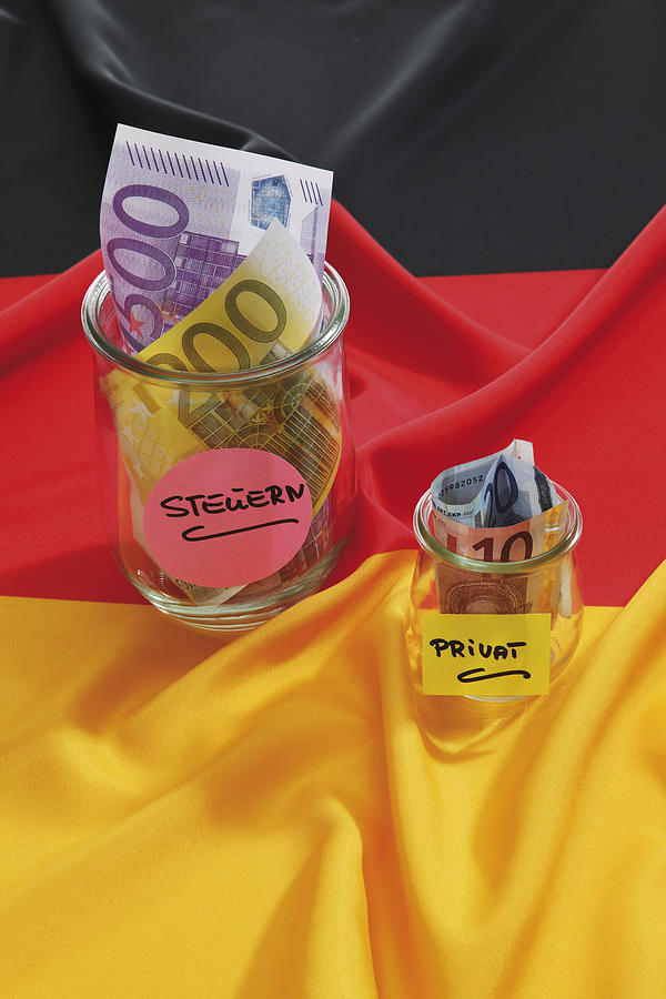 Euro notes in container on german flag Photograph by Tuned_In