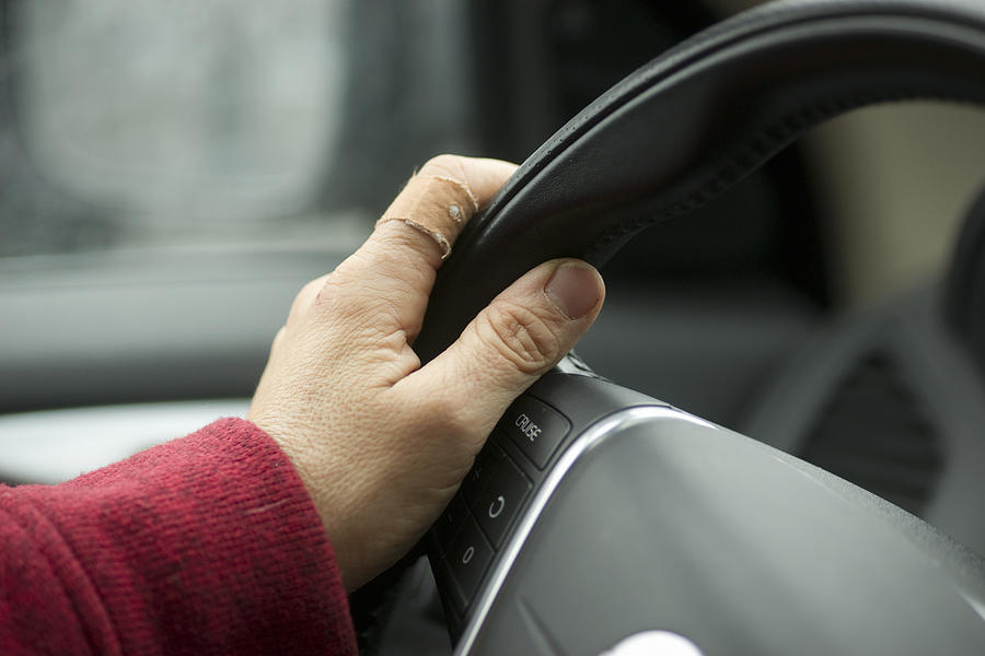 Europe, Germany, Bavaria, View Of Senior Woman Driving Car, Close-Up of Hand Holding Steering Wheel Photograph by Kypros