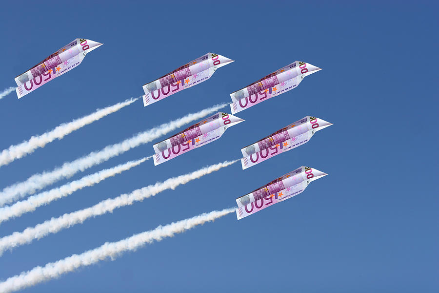 Euros folded into airplanes flying across the sky Photograph by LuisPortugal