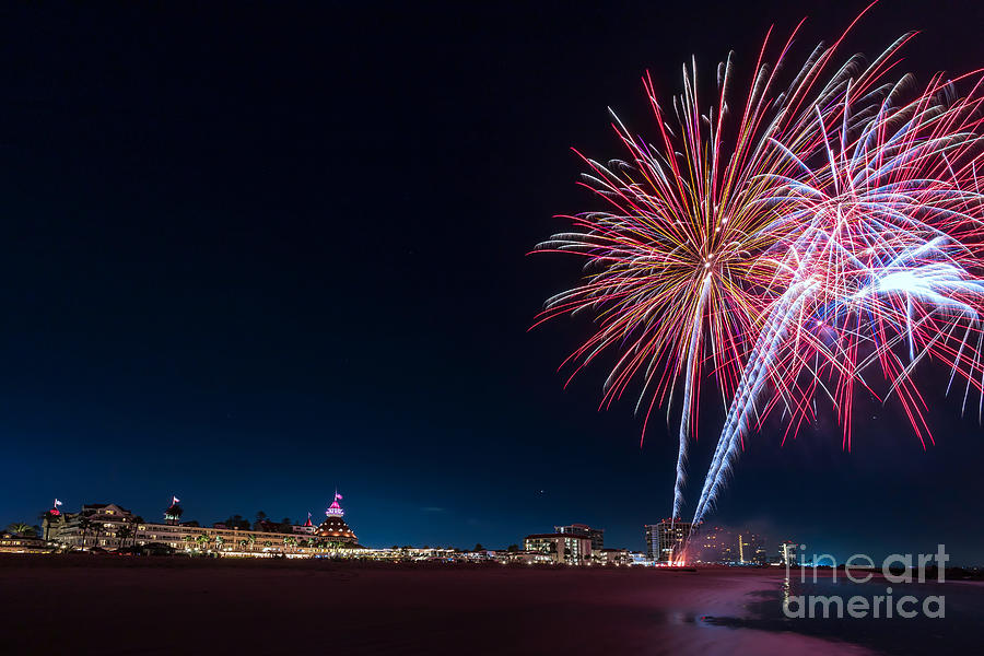 Evening fireworks display at the Hotel del Coronado on the beach along the Pacific Ocean Photograph by Sam Antonio