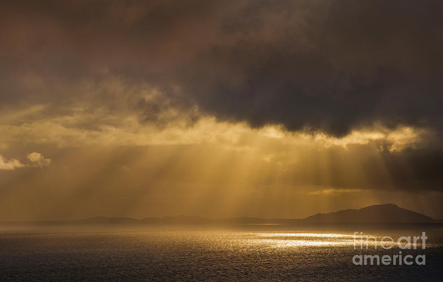Evening light shining through dark stormy clouds onto the sea, Scotland Photograph by Neale And Judith Clark