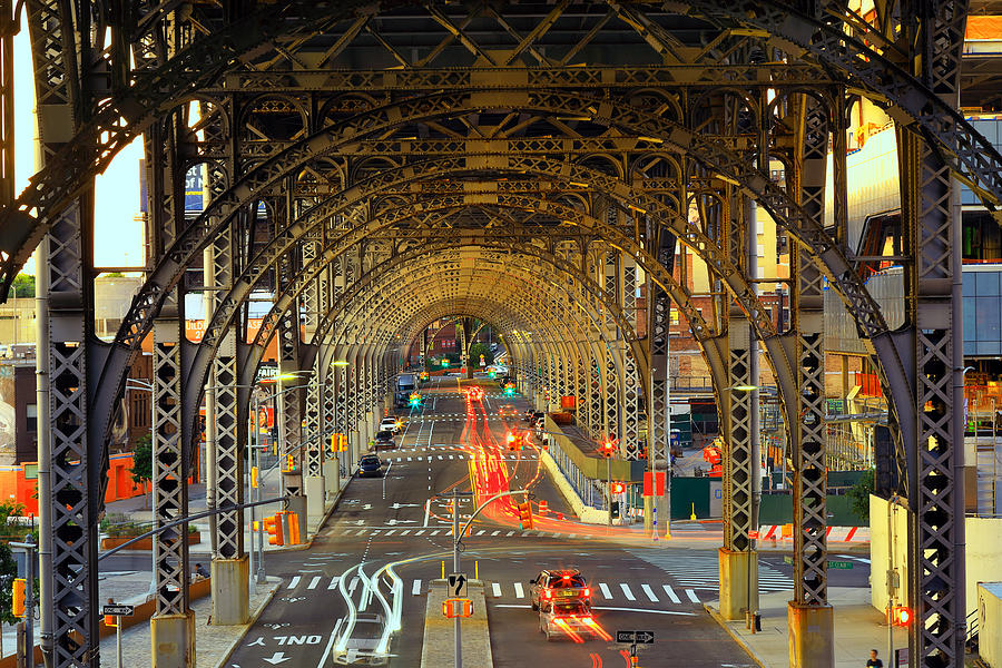Evening traffic with light trails of moving cars belwo a steel viaduct construction Photograph by Rainer Grosskopf