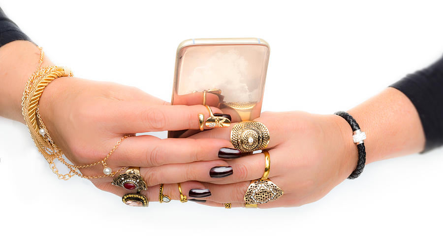 Excessive Jewelry Hands With Dark Nails And Gold Smartphone Photograph by Peter Hermus