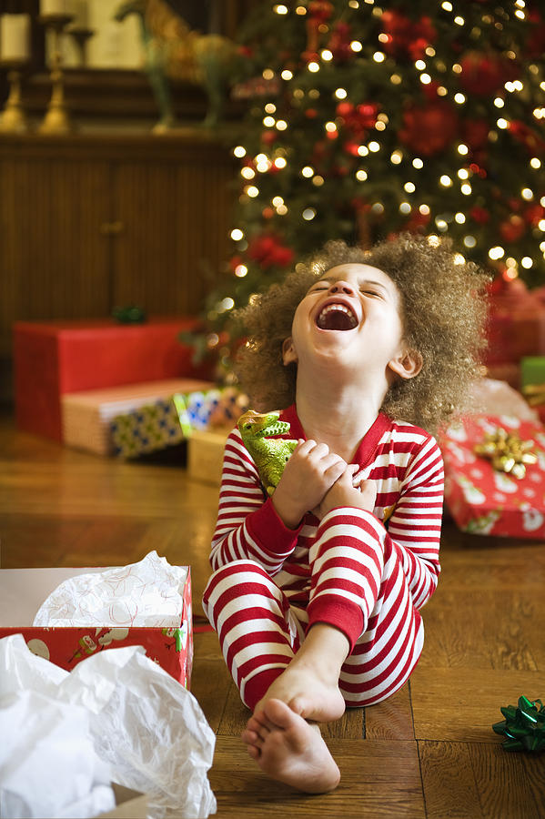 Excited mixed race boy opening Christmas gift Photograph by Jose Luis Pelaez Inc