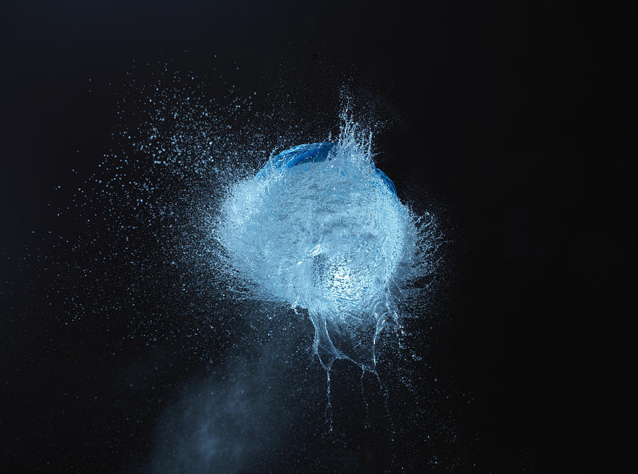 Exploding blue water balloon Photograph by Jonathan Knowles