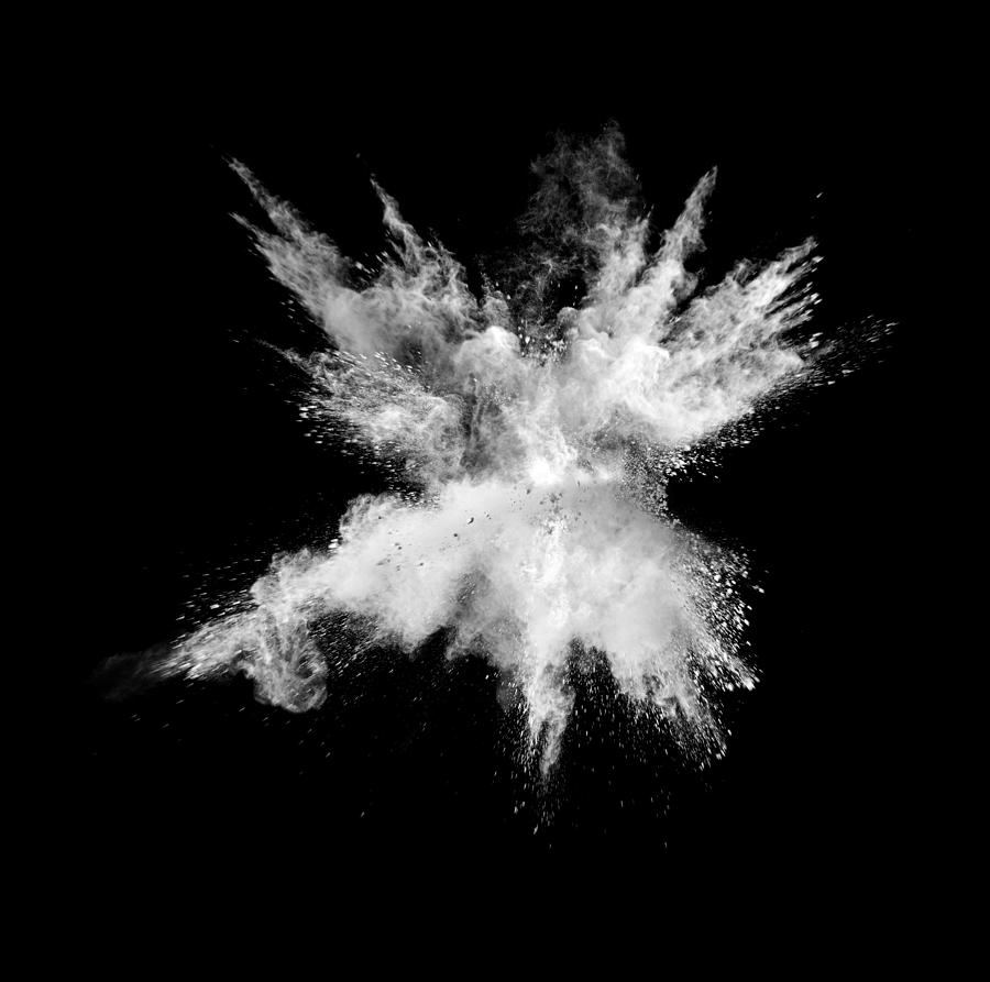 Explosion by an impact of a cloud of particles of powder of white color on a black background. Photograph by Jose A. Bernat Bacete