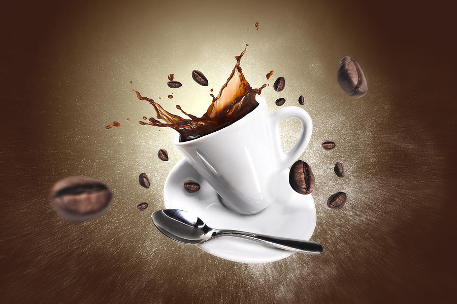 Explosion of coffee with a cup and beans Photograph by Bembodesign