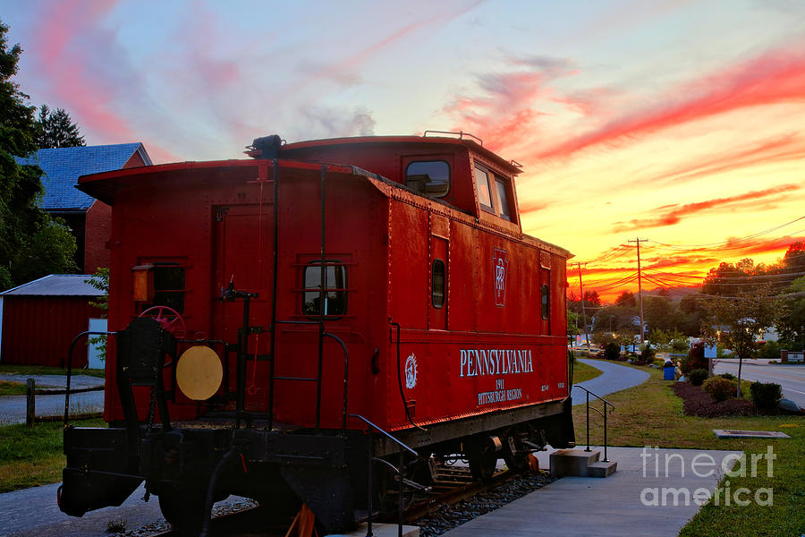 Export PA Railroad caboose Under Fiery Streaks Photograph by Adam Jewell