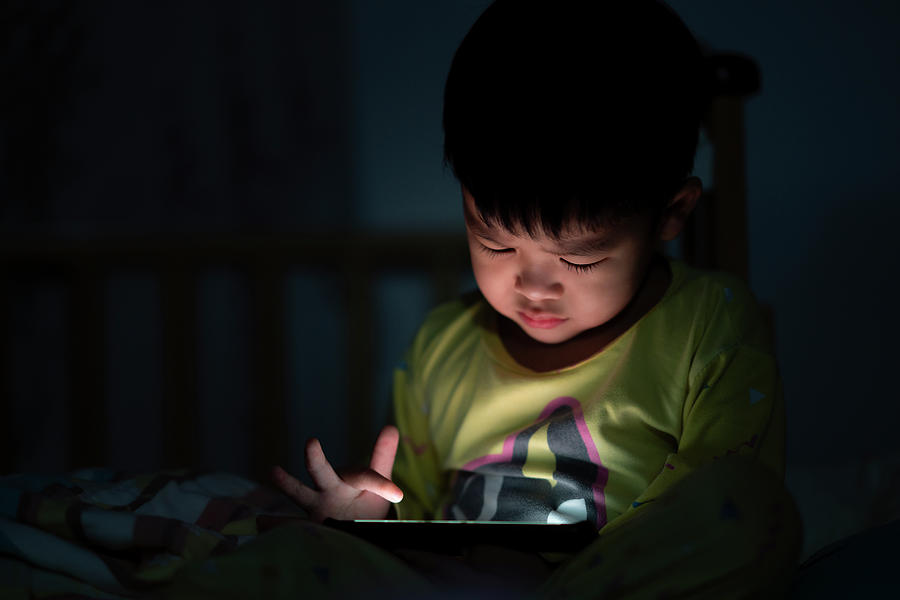 Eye close up Little boy are watching video in tablet on bed  Photograph by Anek Suwannaphoom