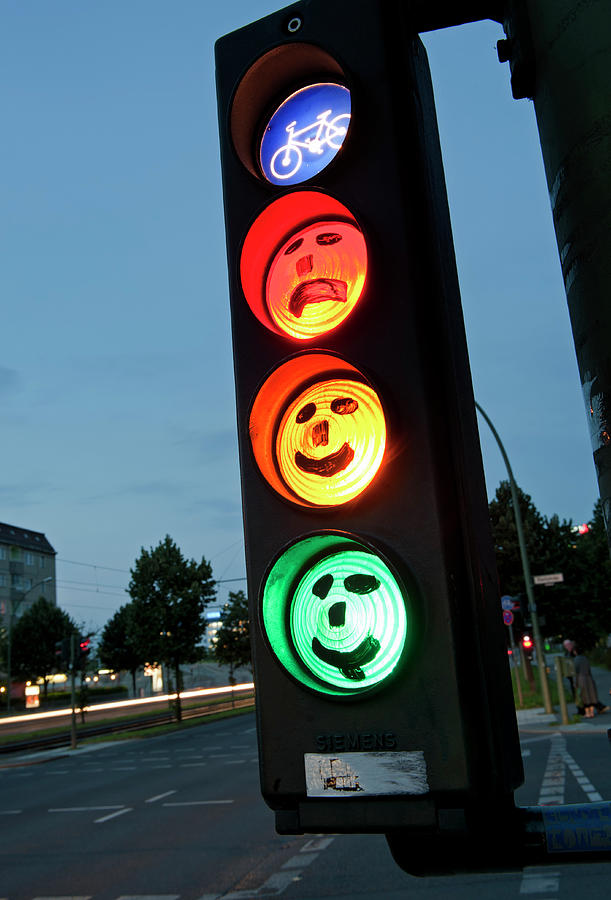 faces drawn onto cycle traffic lights at dusk in Berlin Germany ...