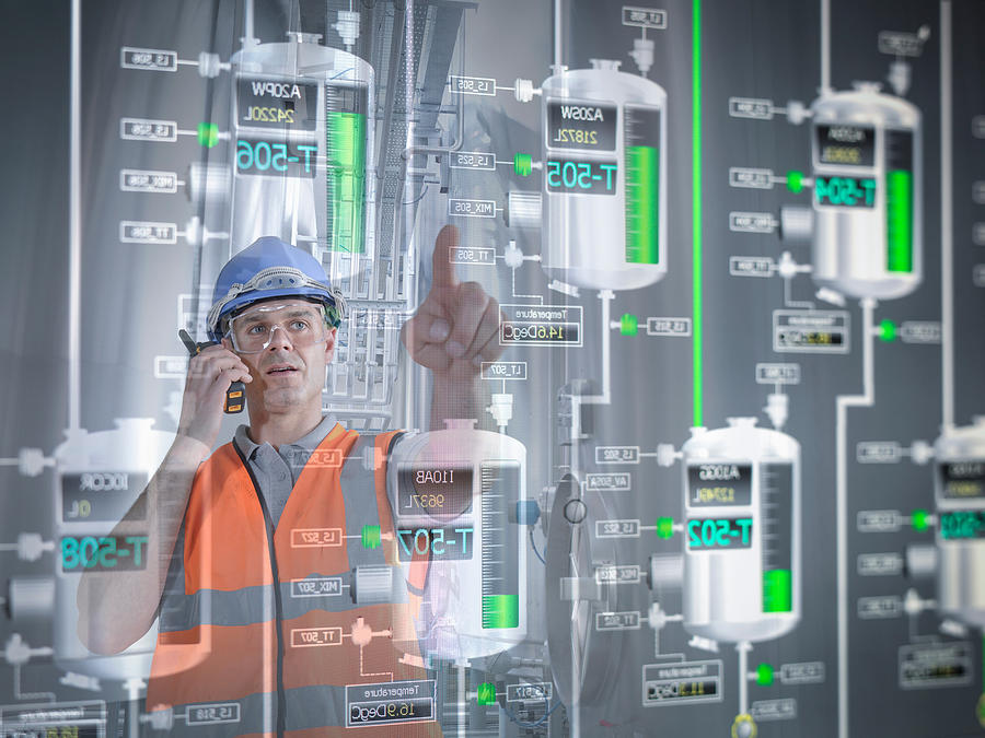 Factory supervisor monitoring product levels on interactive display Photograph by Monty Rakusen