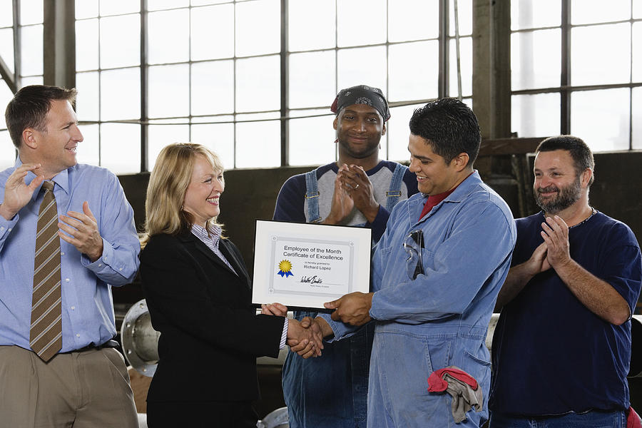 Factory Worker Receiving Certificate Photograph by Fuse