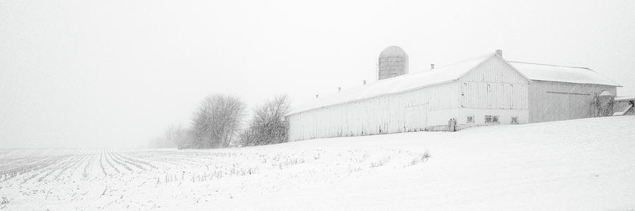 Fade to White - Vanishing point perspective of WI barn in blizzard Photograph by Peter Herman