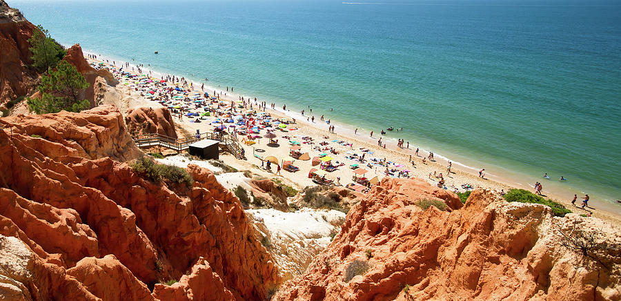 Falesia beach in Portugal. Orange cliffs ending into the blue ocean Photograph by Jean-Luc Farges