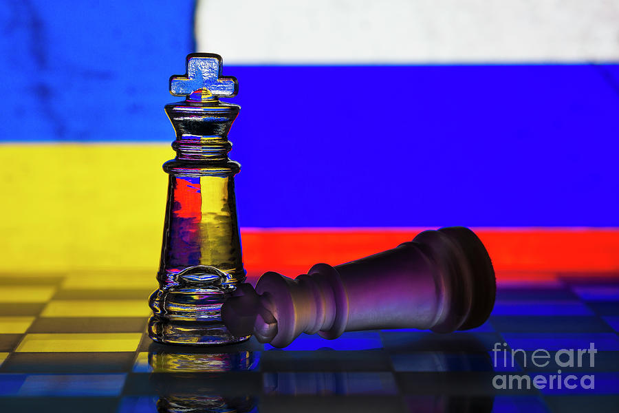 Fallen chess king as a metaphor for fall from power ukraine invasion ukrainian and russian flag background copy space macro Photograph by Pablo Avanzini