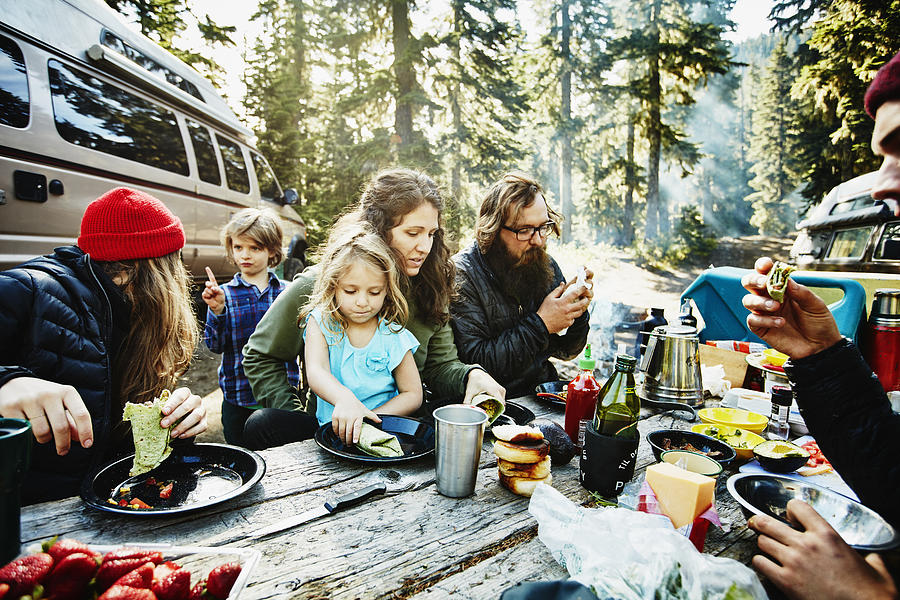 Family and friends eating breakfast while camping Photograph by Thomas Barwick