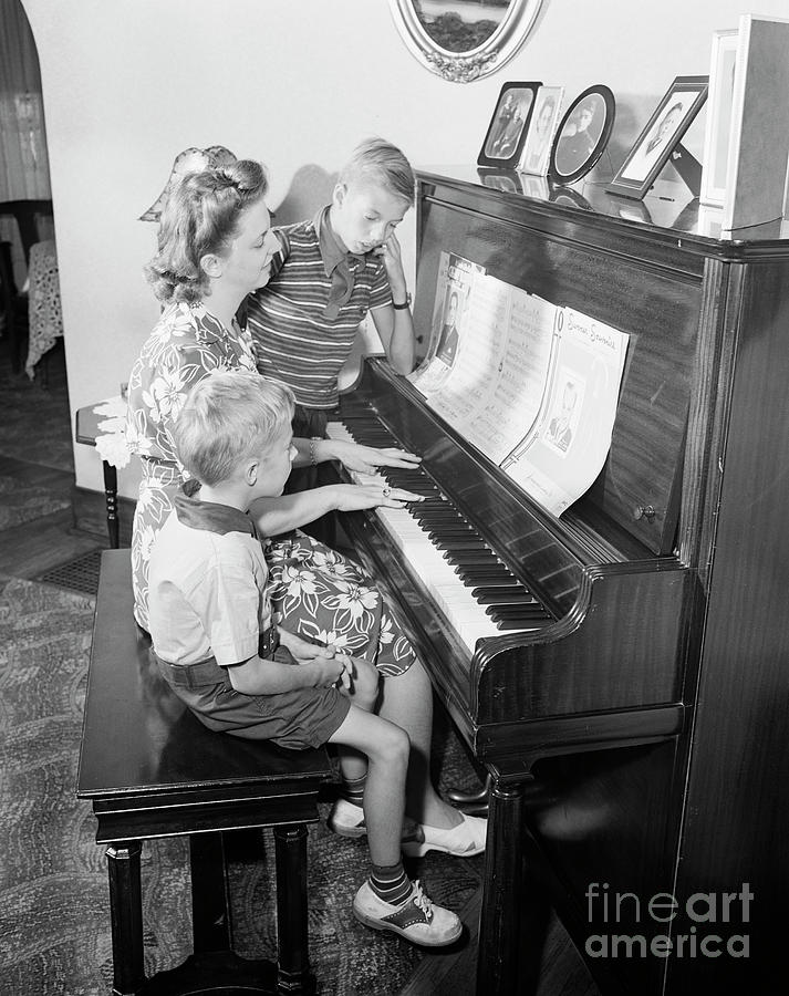 Family At Piano, 1943 Photograph by Granger
