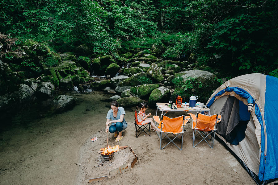 Family camping by stream in forest, Japan Photograph by Ippei Naoi