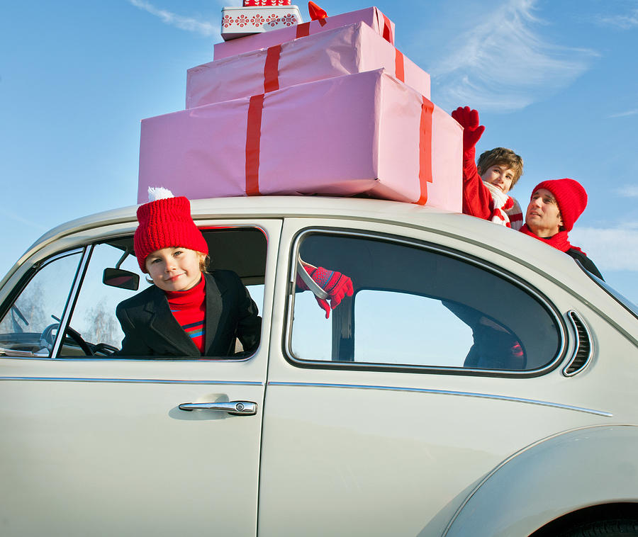 Family car with presents balanced on the roof Photograph by Image Source